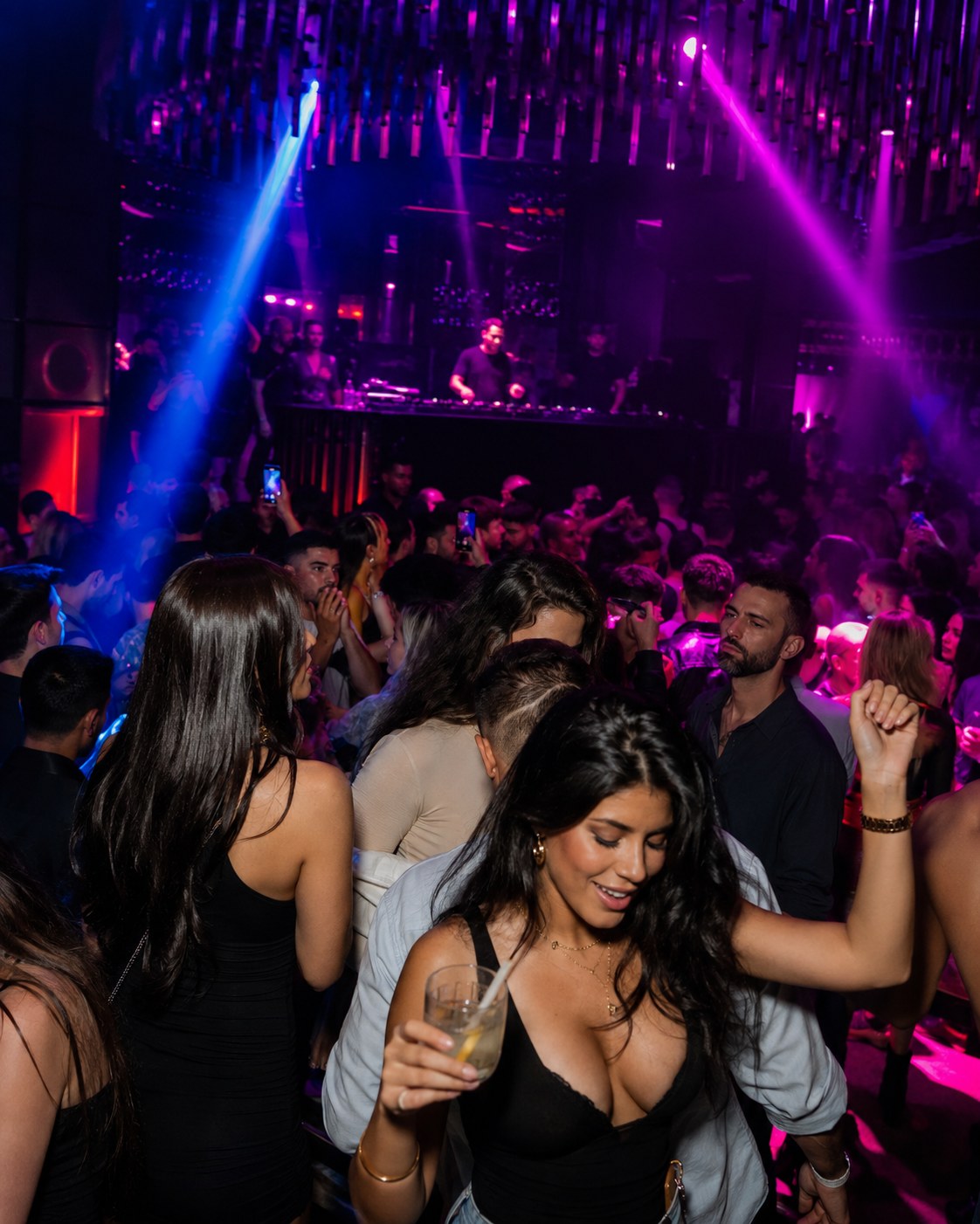 Packed club floor with DJ
