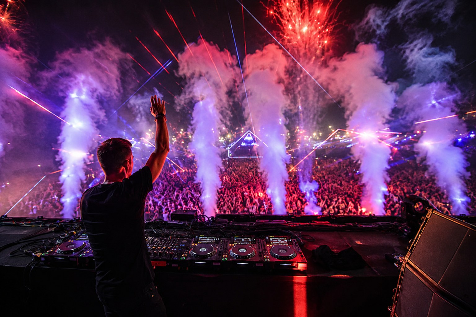 DJ booth facing a huge festival crowd